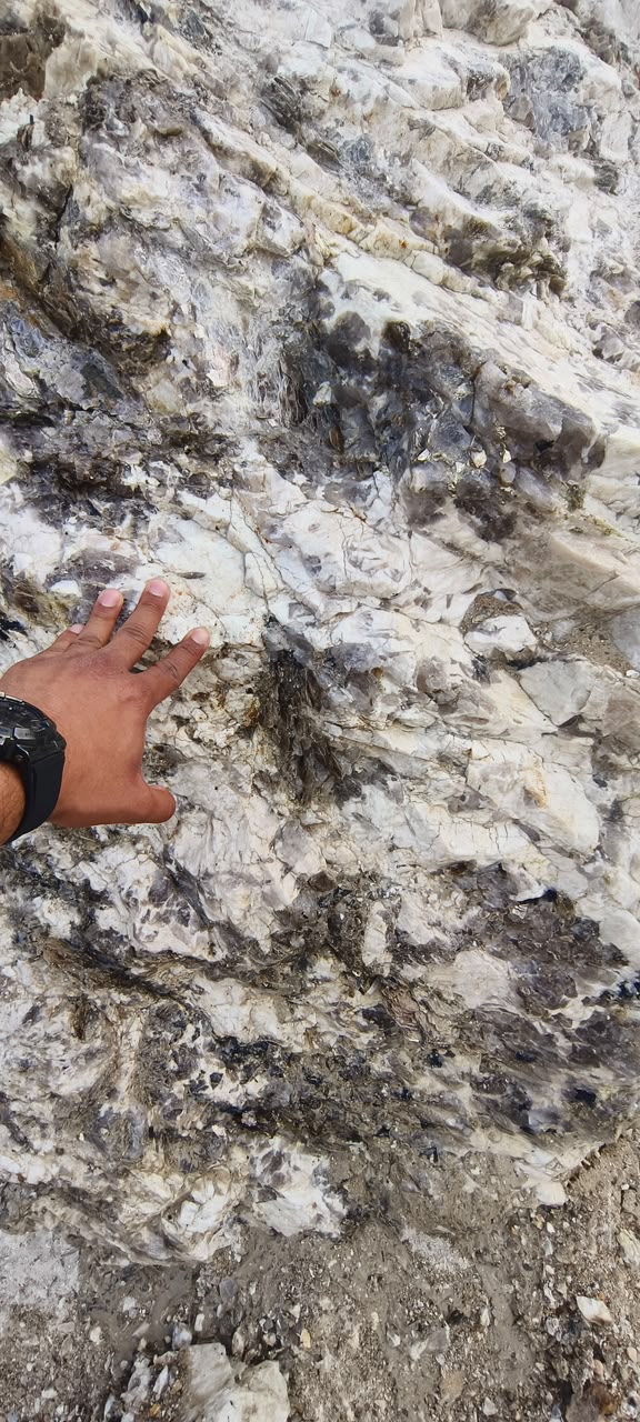 Natural quartz and mica bearing rock face at the quarry